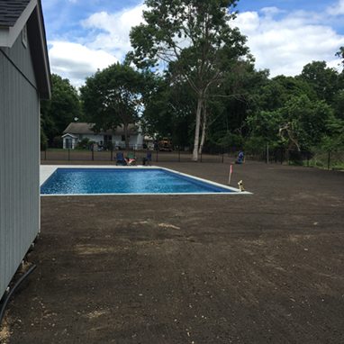 graded soil backyard with large pool